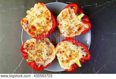 Top View Of A Plate Of Delectable Stuffed Bell Peppers Isolated On Black Table