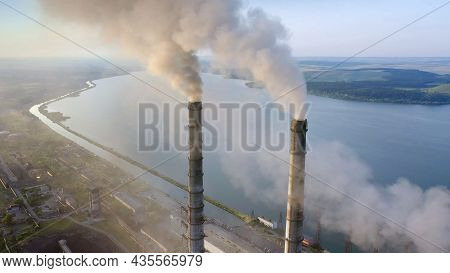 Aerial View Of Coal Power Plant High Pipes With Black Smoke Moving Up Polluting Atmosphere At Sunris