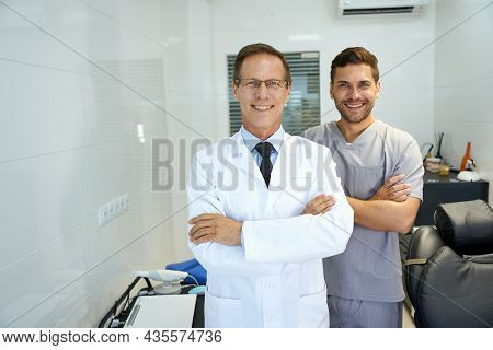 Two Male Dentists Smiling And Looking Professional