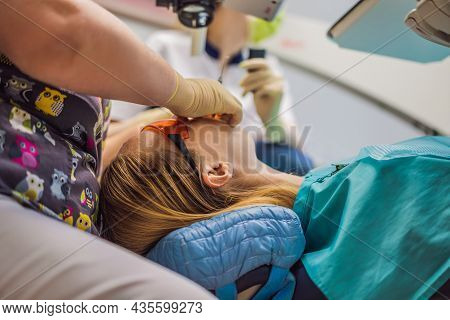 Dental Treatment With A Microscope. Woman Having Teeth Examined At Dentists. Appointment At The Dent