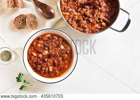 Cowboy Beans With Ground Beef, Jalapeno Pepper And Bacon In Bowl Over White Stone Background With Fr