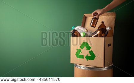 Climate And Environmentally Conservation Concept. Recycling Corrugated Box With Full Of Plastic And 