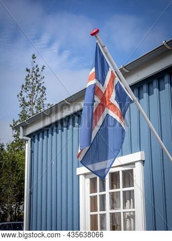 Hafnarfjordur, Iceland - July 17, 2021:
Icelandic Flag On A Blue Building Of Hafnarfjordur Museum. S