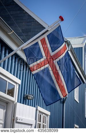 Hafnarfjordur, Iceland - July 17, 2021:
Icelandic Flag On A Blue Building Of Hafnarfjordur Museum. S