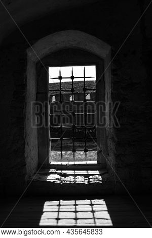 An Old Window In A Gothic Castle With An Iron Grate Casting A Shadow On The Floor. Horror Mystic Hal