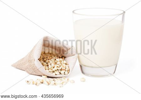 Isolated Milk And Seed Millet. Glass Milk With Seed Millet In Hemp Fabric Bag On White Background. H