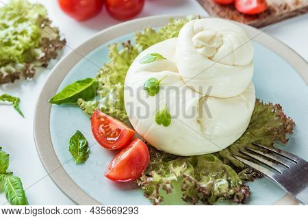 Mozzarella Burrata Salad With Basil Leaves And Ripe Red Tomatoes. Healthy Salad With Traditional Ita