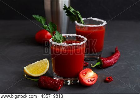 Fresh Tomato Juice With Pepper, Spices, Salt And Yellow Lemon In Glass With Copy Space. Bloody Mary 