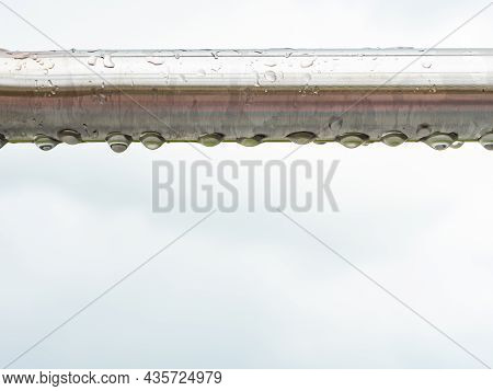 Close Up Of Raindrops On A Stainless Steel  Bar. Chrome Steel Construction On Workout Place