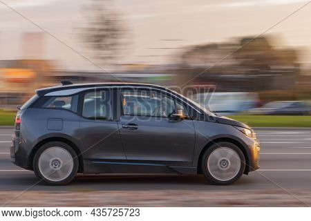 The Bmw I3 Electric Car Drives Down The Street At Sunrise. Motion Blur. Riga, Latvia - 06 Oct 2021.