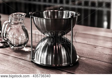 Winery Tasting, A Carafe Of Water And A Metal Vessel On The Table