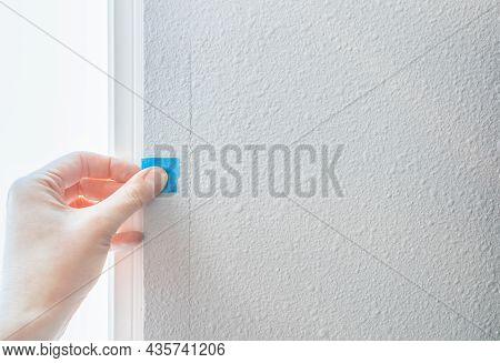 Person Hand Stick Blue Sticker On Paint Cracked Wall, Checking Quality House From Defect Constructio