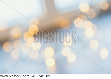 Many Blurred Small Electric Bulbs On A Wall. Yellow Blurred Lights. Wall Of Christmas Lights