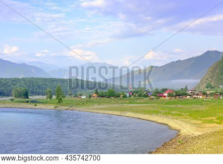 The Bank Of A Mountain River Under A Blue Cloudy Sky. Altai, Siberia, Russia