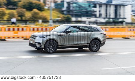 Range Rover Velar Test Drive At The City Streets. Premium Suv Car Driving On Urban Highway With Moti