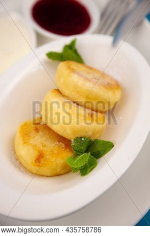 A Portion Of Three Round Curd Cheese Pancakes On A White Plate. Healthy Breakfast. Food Background