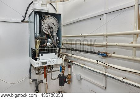 Boiler and pipes of the heating system of a house, cover removed for furnace reapirs