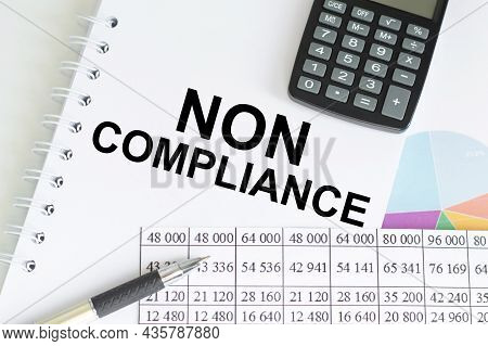 Business Concept. Top View Notebook With Text Non Compliance On The Chart Background And Calculator