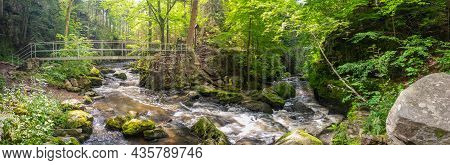 Bend Of The Wild River With An Iron Footbridge, In The Woods, With Rapids And Rocks, Doubrava River 