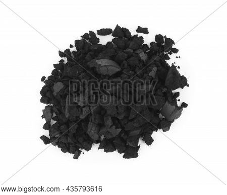 Pile Of Crushed Activated Charcoal Pills On White Background, Top View. Potent Sorbent