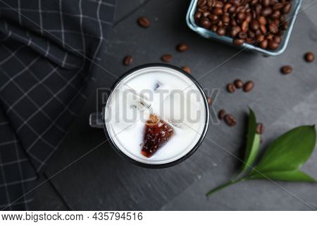 Glass Cup Of Milk With Delicious Grass Jelly, Green Leaf And Coffee Beans On Black Table, Flat Lay