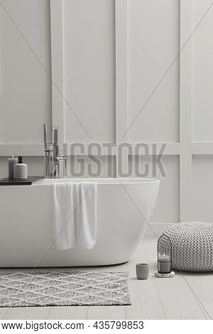 Modern Ceramic Bathtub Near White Wall Indoors