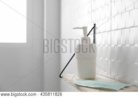 Hand Sanitizer And Face Masks On A Shelf In Bathroom. Coronavirus Covid-19 Hand Hygiene Prevention.