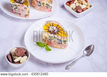 Nut Cake With Cream And Icing On A White Plate On A Marble Background