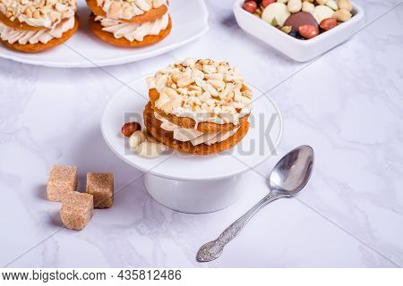 Peanut Cake With Cream On White Plate On Marble Background