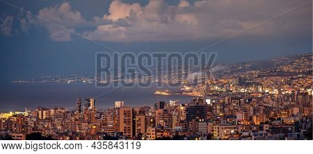 Beautiful Night Landscape of a Coastal City. Houses with Glowing Windows in Evening Light. Gorgeous Mountainous Town. Jounieh. Lebanon.