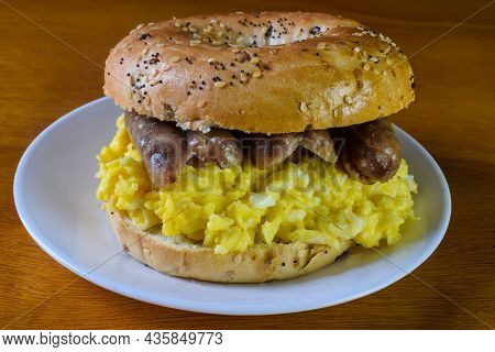Scramble Egg  With Sausage Between An Everything Bagel,