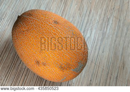 Ripe Whole Fruit Melon Lies On A Gray Background Close-up