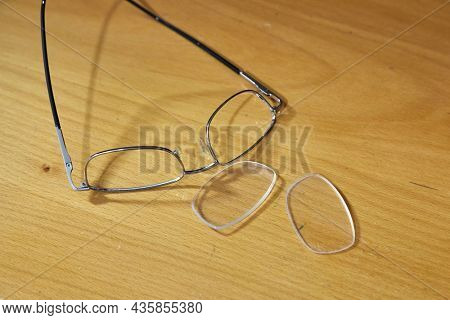 Glasses broken and mangled on the floor after stepping on them