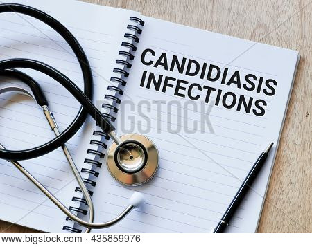 Phrase Candidiasis Infections Written On Note Book With Stethoscope And A Pen. Medical And Health Co