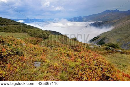 Autumnal Landscape In Alps Mountain With Red Bush And Viewclouds In Valley- Col Du Petit Saint Berna
