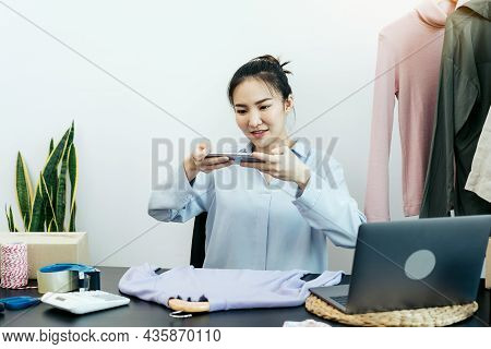 Asian Entrepreneurs Chatting With Customers And Taking Pictures Of Their Products Sent To Choose Fro