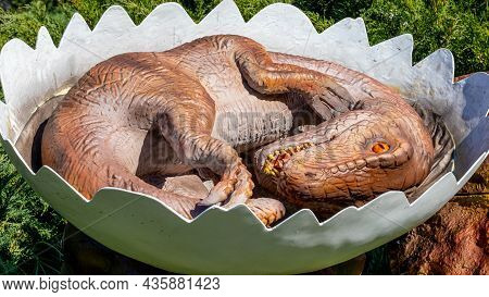 Ukraine, Khmelnitsky, October 2021. Model Of A Newborn Dinosaur Eoraptor In An Egg