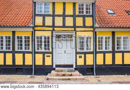Front Facade Of A Yellow Half Timbered House In Viborg, Denmark
