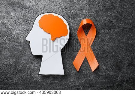 Human Head Cutout, Brain And Orange Ribbon On Grey Table, Flat Lay. Multiple Sclerosis Concept