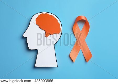 Human Head Cutout, Brain And Orange Ribbon On Light Blue Background, Flat Lay. Multiple Sclerosis Co