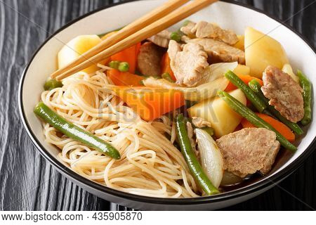 Nikujaga Japanese Style Meat And Potatoes Stew Close Up In Bowl On The Wooden Table. Horizontal