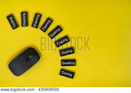 Layout Of Mouse And Wooden Tiles With Texts Of Cyberbullying Actions. Cyberbullying Concept