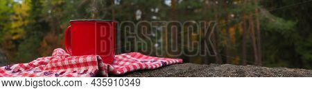 Banner Red Cup With A Hot Drink And Steam On A Stone And A Cozy Closet Towel With Forest Motifs Agai