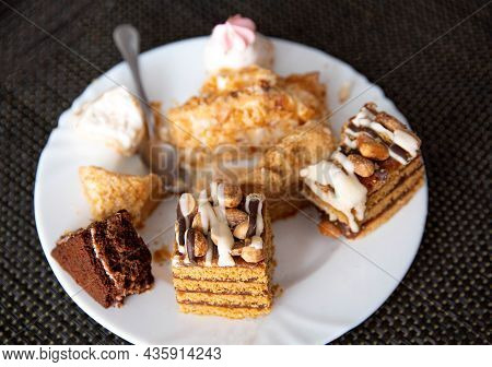 The Remains Of Pastries And Cake In A Plate On The Table. Harmful Delicious Sweet Food. Close-up, Fi