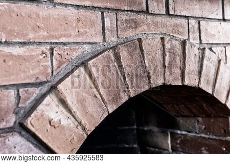 Old Fireplace Made Of Red Brick With Arch Close Up Gray Tones