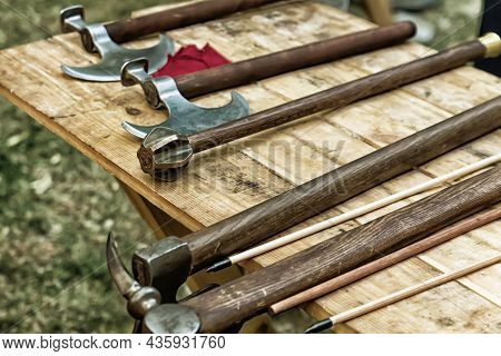 Counter Of Medieval Gunsmith Battle Ax, Mace On Wooden Background