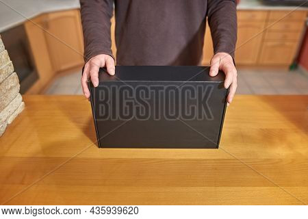 Shop assistant showing a blank black box of computer hardware equipment for buying, distributor office