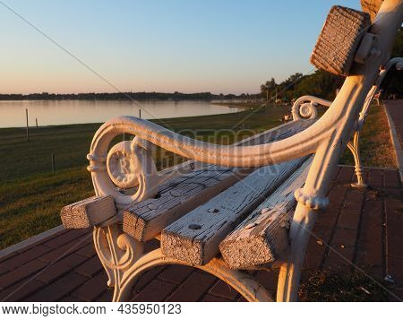 Palic, Serbia September 10, 2021. Metal Bench Overlooking Lake Palic. The Seat Is White. R Letter On