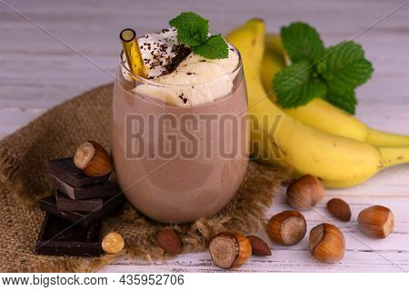 Chocolate Banana Smoothie With Cream And Nuts .
