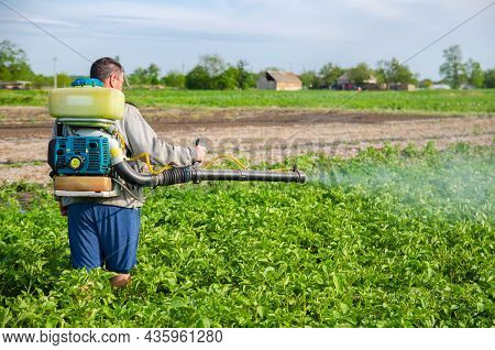 Kherson Oblast, Ukraine - May 22, 2021: Farmer Sprays A Potato Plantation With A Sprayer. Mist Spray
